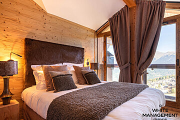 A living room with a couch and chairs and a sink