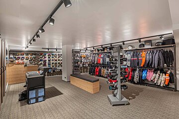 The inside of a store with clothes and helmets on display