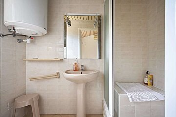 A bathroom with a sink a mirror and a water heater