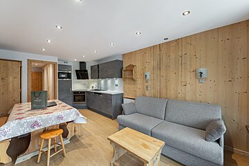 A living room with a couch and a table with a bag that says