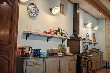 A kitchen with a blue and white plate on the wall