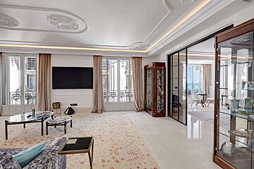 A living room with a flat screen tv on the wall
