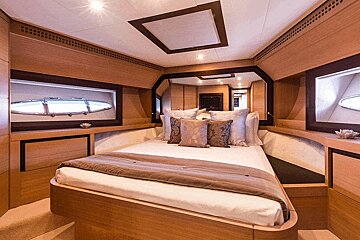 A bedroom on a boat with a bed and pillows