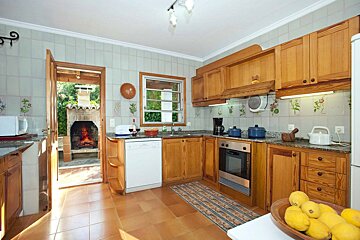 A kitchen with a bowl of lemons on the counter