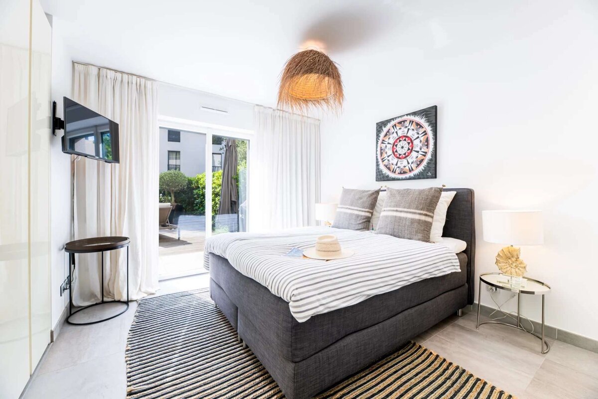 A bedroom with a large bed and a television