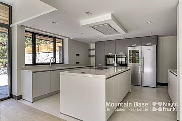 A kitchen with stainless steel appliances from mountain base immobilier real estate