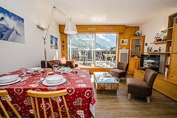 A living room with a red table cloth with hearts on it