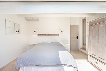 A bedroom with a bed and a sign on the wall that says 