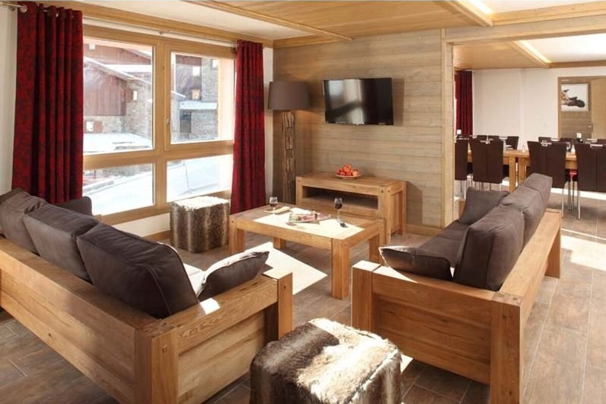 A living room with wooden furniture and a flat screen tv