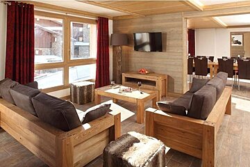 A living room with wooden furniture and a flat screen tv