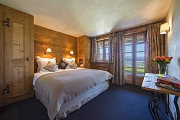 A bedroom with a bed and a book on a table