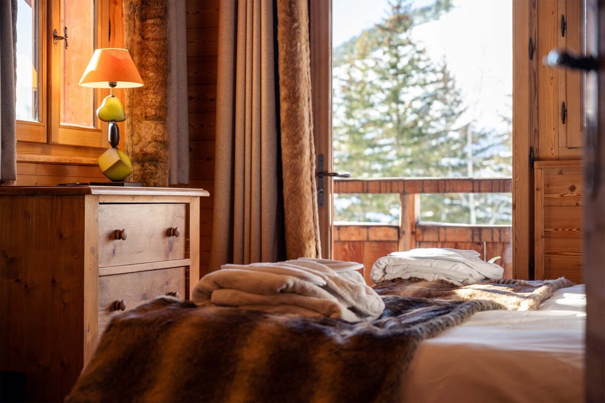 A bedroom with a dresser and a lamp with pears on it