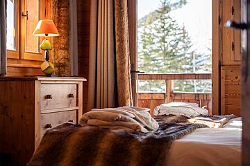 A bedroom with a dresser and a lamp with pears on it