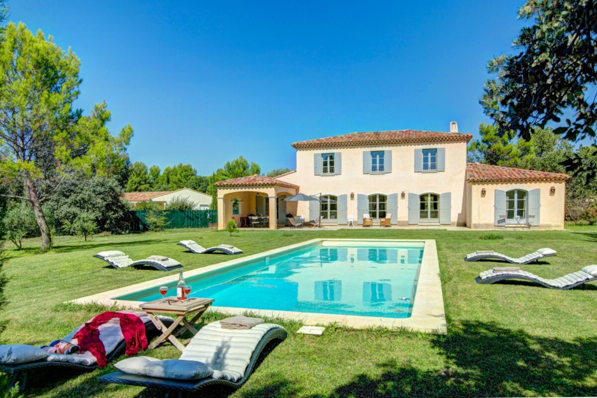 A large house with a swimming pool in front of it