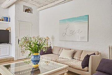 A living room with a couch and a painting that says love