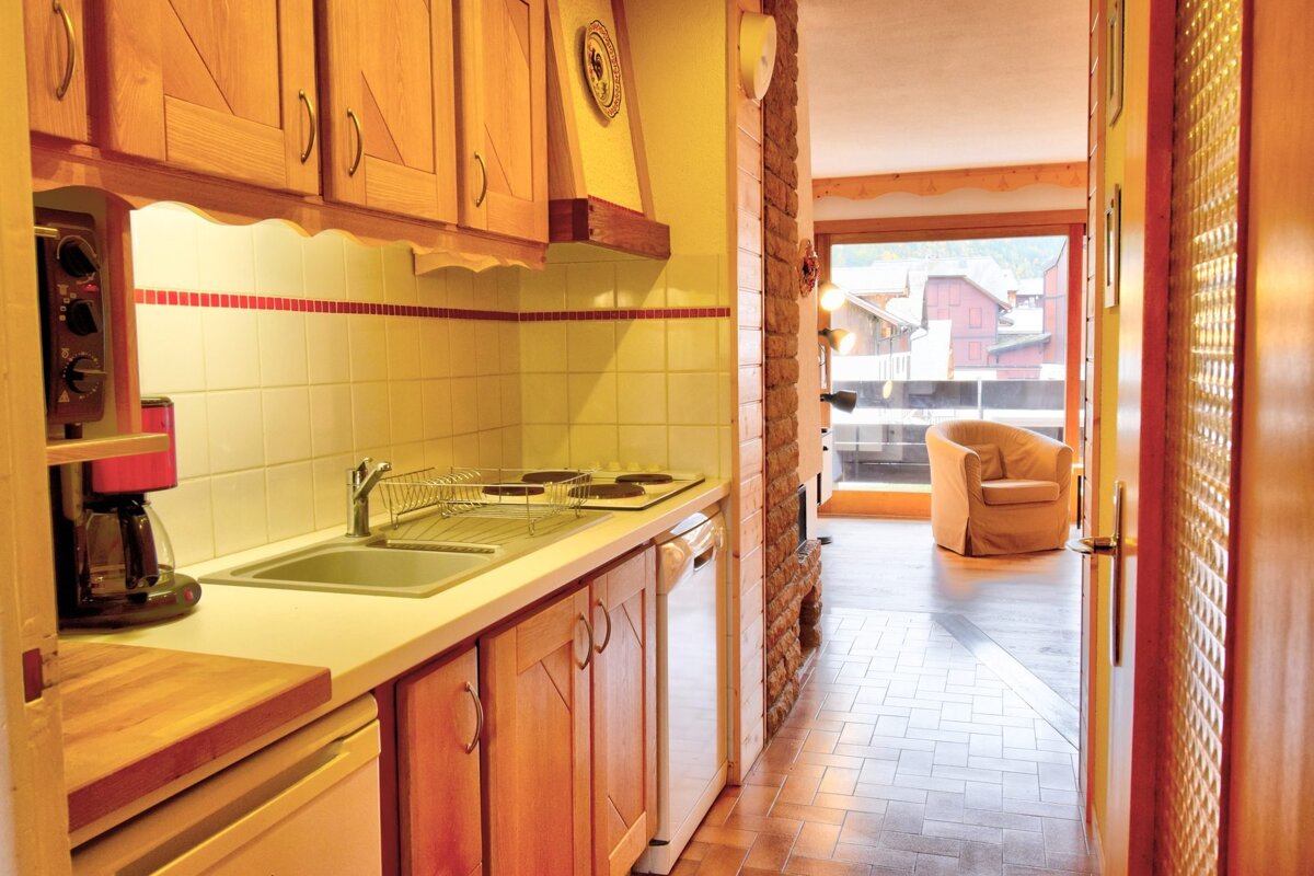 A kitchen with wooden cabinets and a stove top oven