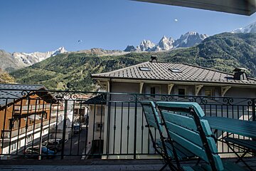 A balcony with a view of a mountain range