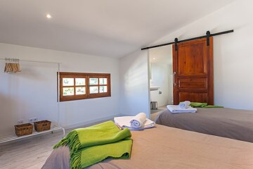 A bedroom with two beds and a sliding barn door