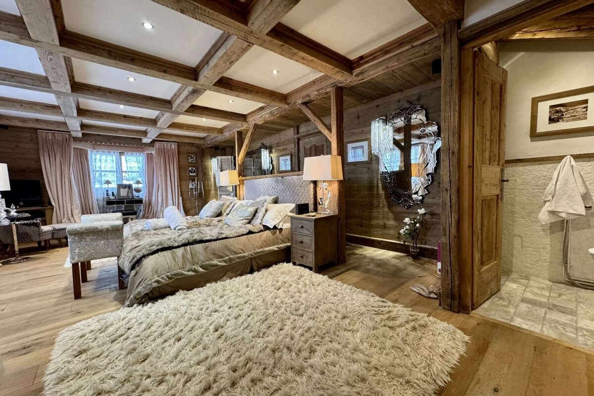 A bedroom with a large bed and a rug