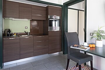 A kitchen with a table and chairs and a magazine on it