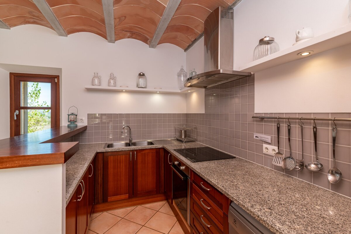 A kitchen with granite counter tops and wooden cabinets