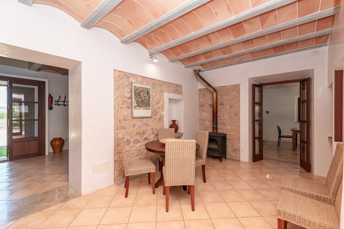 A room with a table and chairs and a picture on the wall