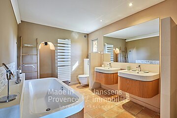 A bathroom with two sinks and a bathtub made in provence