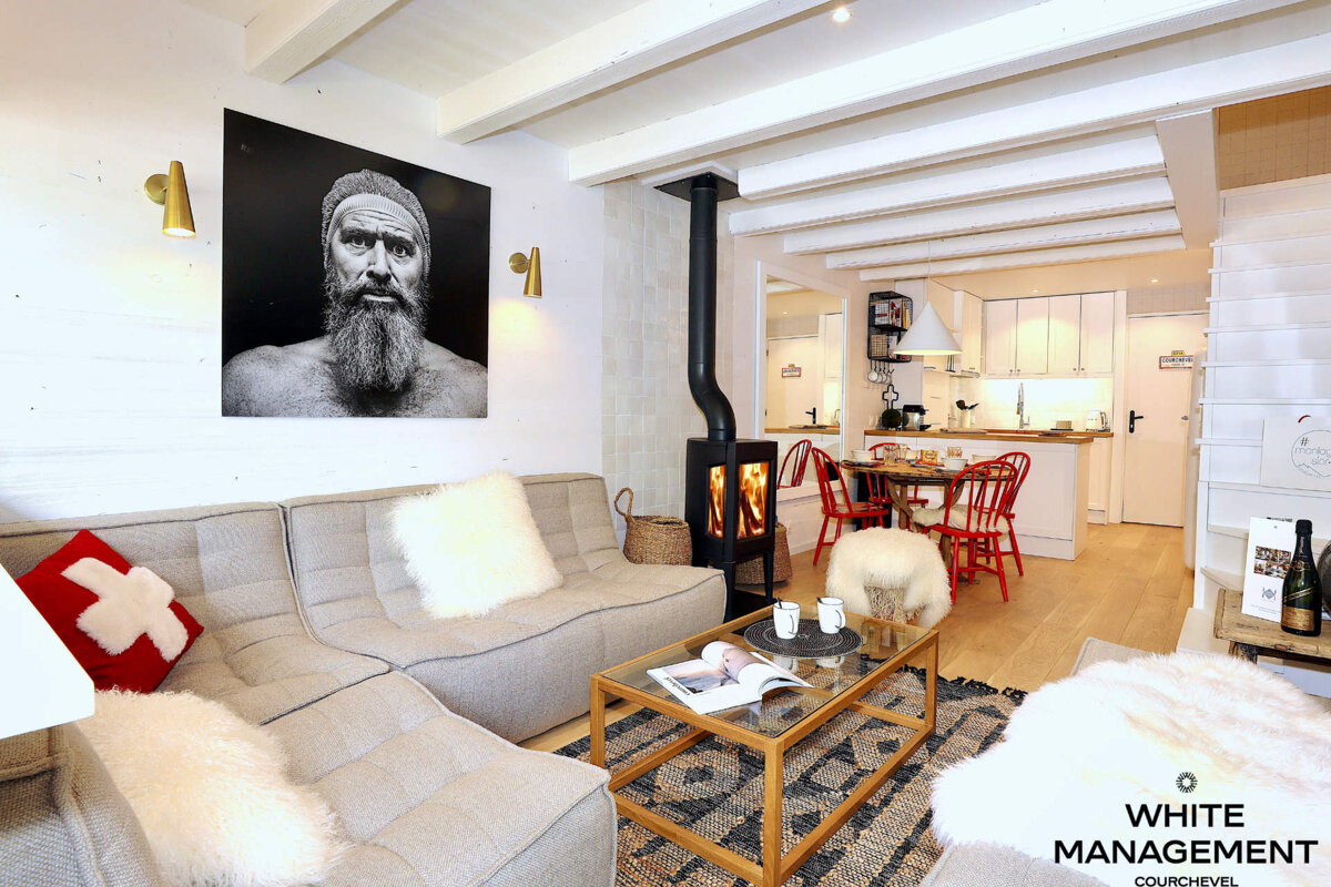 A living room with furniture and a sign that says rental designer luxury rental