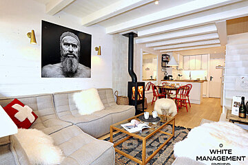 A living room with furniture and a sign that says rental designer luxury rental