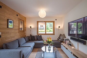 A living room with a couch and a flat screen tv