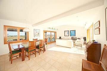 A living room with a dining table and chairs