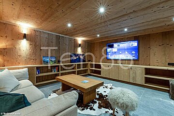 A living room with a large flat screen tv on the wall