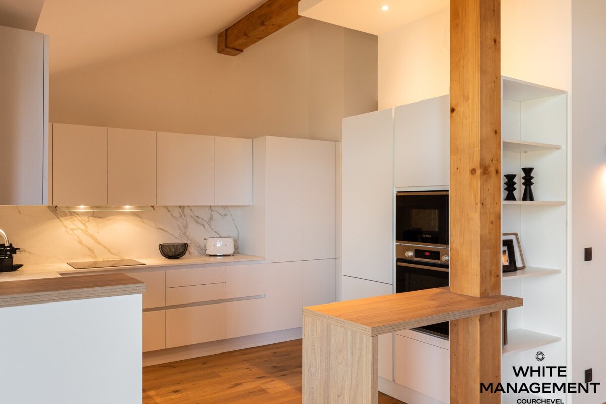 A bunk bed in a room with pink cabinets