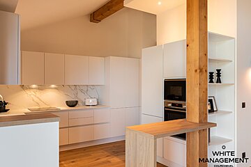 A bunk bed in a room with pink cabinets