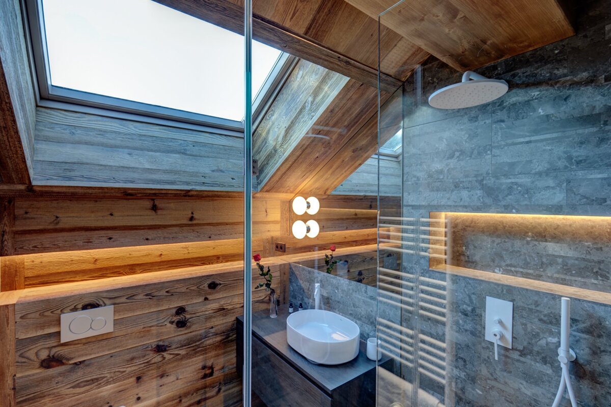 A bathroom with a skylight and a sink