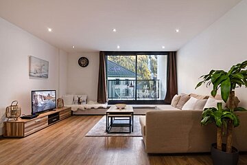 A living room with a couch and a flat screen tv