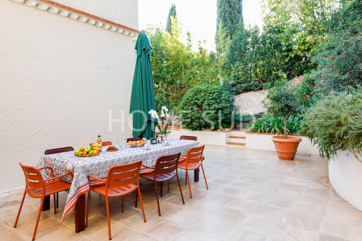 A table and chairs on a patio with the word home visible