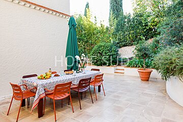 A table and chairs on a patio with the word home visible