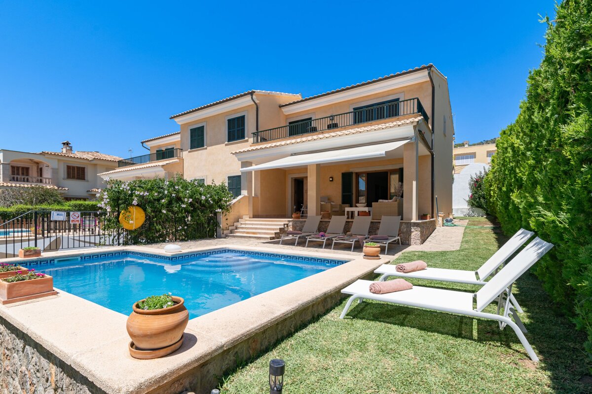 A large house with a swimming pool in front of it