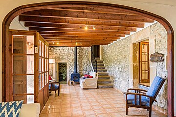 A living room with a wood stove and stairs