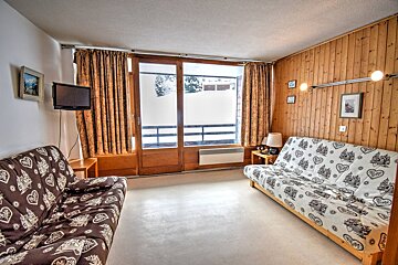 A living room with a couch and a flat screen tv