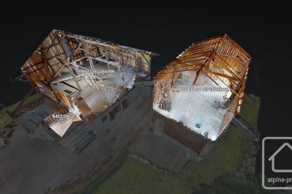 Aerial 3D model of two open-roofed barn structures, revealing wooden interiors and floors. French text labels 