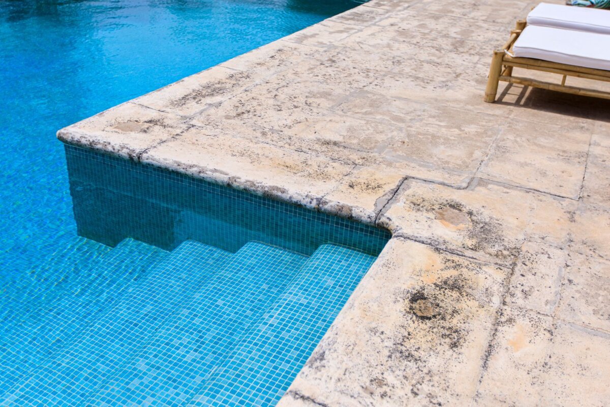 A swimming pool with stairs leading up to it