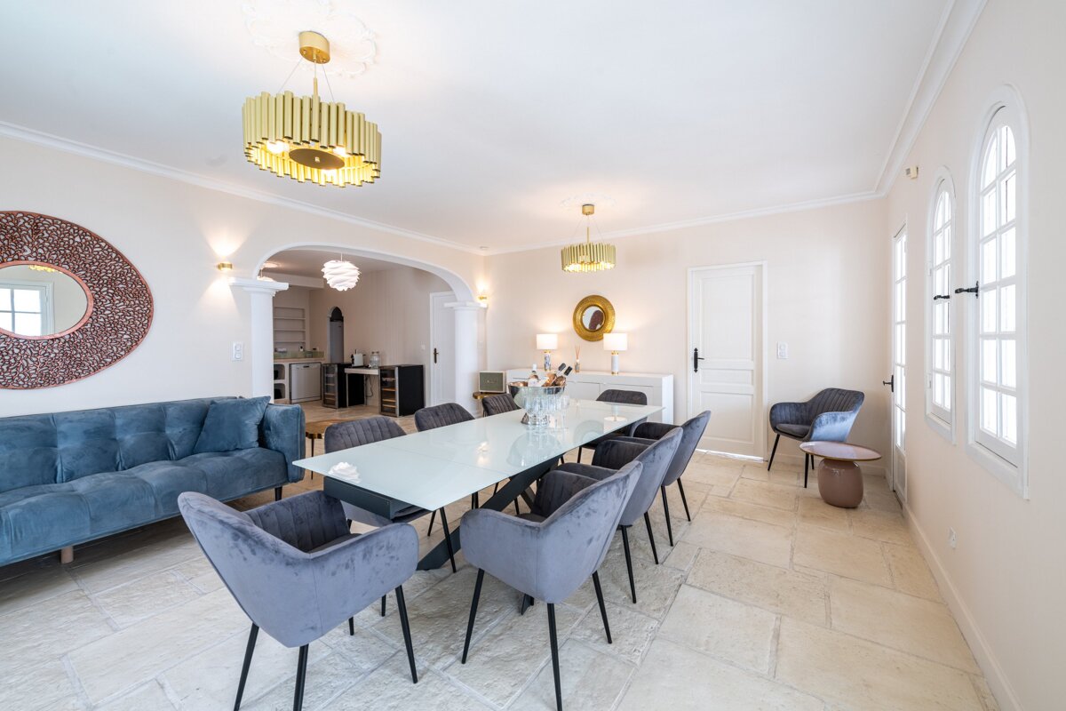 A dining room with a long table and chairs