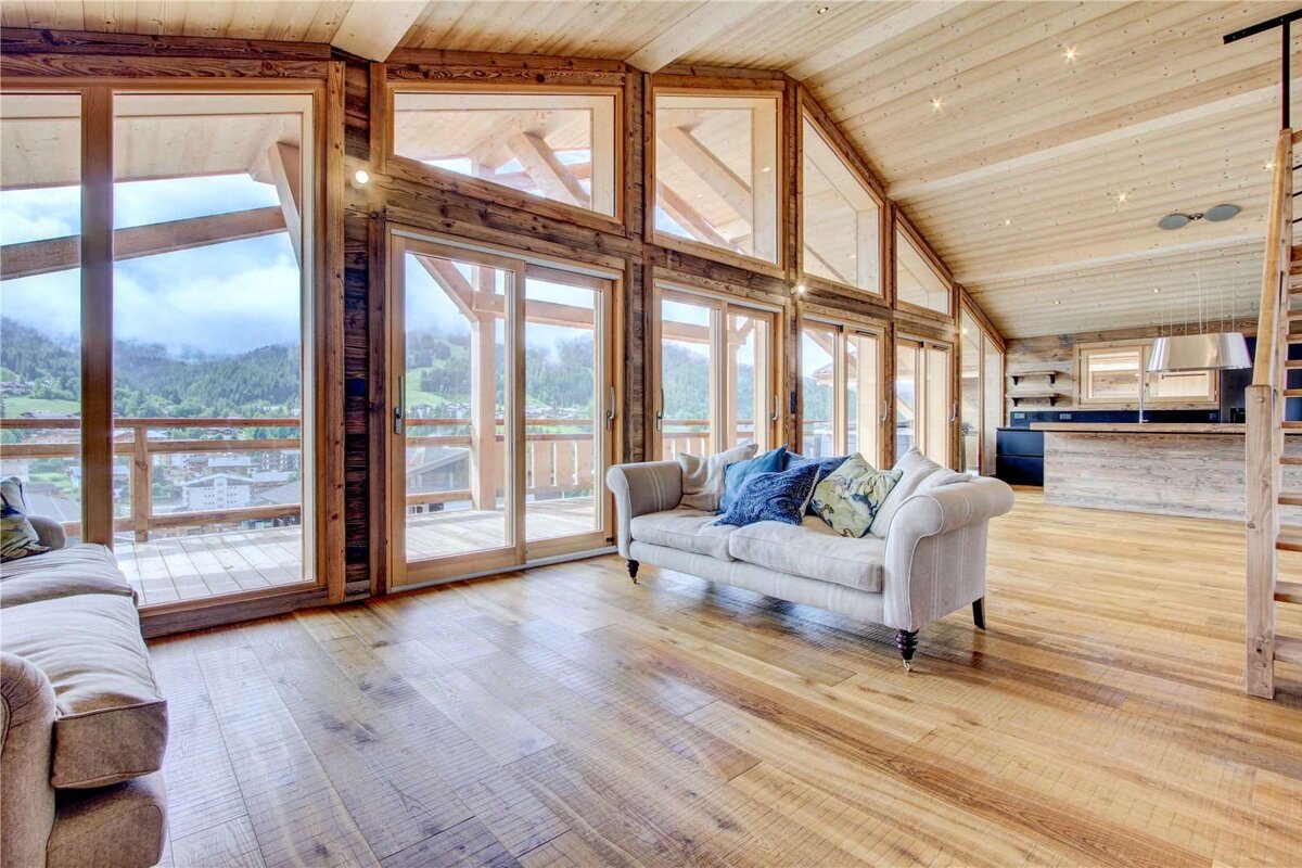 A living room with a couch and lots of windows