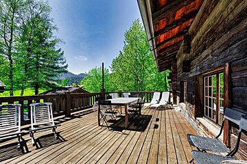 A wooden deck with a table and chairs on it
