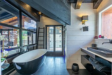 A bedroom with a bed and a picture of a wolf on the wall