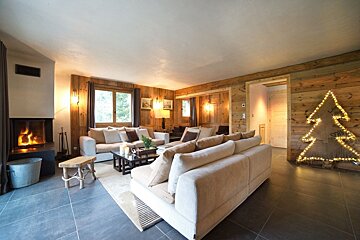 A living room with a fireplace and a christmas tree