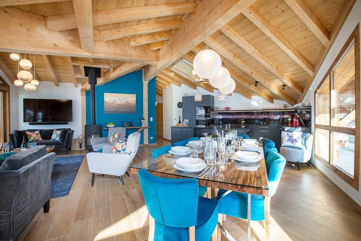 A living room with a dining table and chairs
