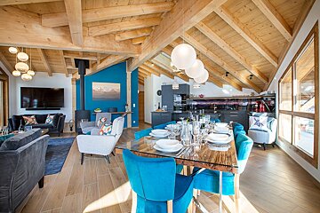 A living room with a dining table and chairs